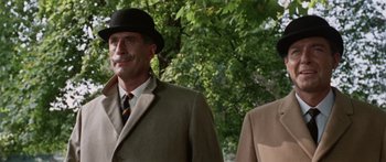 Movie still from “The Ipcress File” (1965), directed by Sidney J. Furie – A man in a suit and a hat standing next to a man in a suit; Close Up shot, Low angle