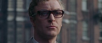 Movie still from “The Ipcress File” (1965), directed by Sidney J. Furie – A person wearing glasses; Close Up shot, Low angle