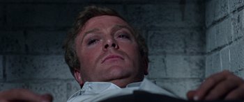 Movie still from “The Ipcress File” (1965), directed by Sidney J. Furie – A man's face as he looks upward; Close Up shot, Overhead angle