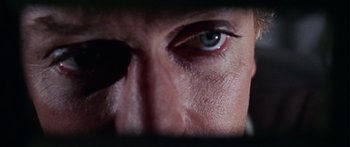 Movie still from “The Ipcress File” (1965), directed by Sidney J. Furie – A person's eye with a black spot; Extreme Close Up shot, Overhead angle