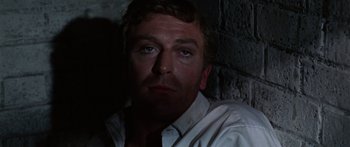 Movie still from “The Ipcress File” (1965), directed by Sidney J. Furie – A person wearing a white shirt; Close Up shot, Low angle