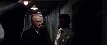 Movie still from “The Ipcress File” (1965), directed by Sidney J. Furie – Two men are talking in an alley way; Medium shot, High angle