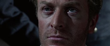 Movie still from “The Ipcress File” (1965), directed by Sidney J. Furie – A man's face with blue eyes; Close Up shot, Low angle