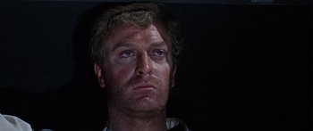 Movie still from “The Ipcress File” (1965), directed by Sidney J. Furie – A person wearing a white shirt; Close Up shot, Low angle