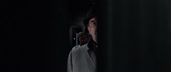 Movie still from “The Ipcress File” (1965), directed by Sidney J. Furie – A man wearing a hat and a jacket; Close Up shot, Low angle