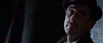 Movie still from “The Ipcress File” (1965), directed by Sidney J. Furie – A person wearing a hat; Close Up shot, Low angle