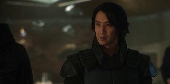 Movie still from “Altered Carbon” (2018), created by Laeta Kalogridis – A man in a black jacket is looking to his left; Close Up shot, Over the shoulder angle