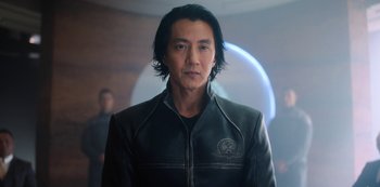 Movie still from “Altered Carbon” (2018), created by Laeta Kalogridis – A man with long black hair wearing a leather jacket; Close Up shot, Over the shoulder angle