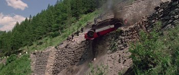 Movie still from “The Italian Job” (1969), directed by Peter Collinson – A car that is falling off of the side of a hill; Extreme Wide shot, High angle