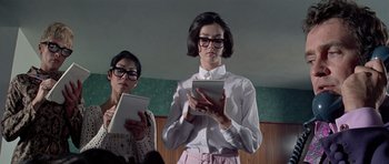 Movie still from “The Italian Job” (1969), directed by Peter Collinson – Two women are standing in front of each other; Medium shot, Low angle
