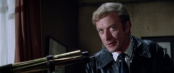 Movie still from “The Italian Job” (1969), directed by Peter Collinson – A person with a telescope; Close Up shot, Over the shoulder angle