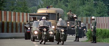 Movie still from “The Italian Job” (1969), directed by Peter Collinson – A group of men riding motorcycles on a street; Wide shot, High angle
