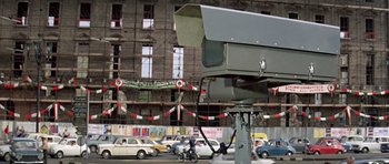 Movie still from “The Italian Job” (1969), directed by Peter Collinson – A traffic camera on the side of the street; Wide shot, Low angle