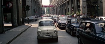 Movie still from “The Italian Job” (1969), directed by Peter Collinson – A bunch of cars that are in the street; Extreme Wide shot, High angle