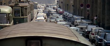Movie still from “The Italian Job” (1969), directed by Peter Collinson – A bunch of cars that are in the street; Extreme Wide shot, High angle