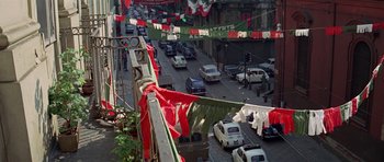 Movie still from “The Italian Job” (1969), directed by Peter Collinson – A busy street filled with traffic and parked cars; Extreme Wide shot, High angle
