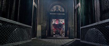 Movie still from “The Italian Job” (1969), directed by Peter Collinson – A large red truck parked inside of a building; Wide shot, Low angle