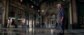 Movie still from “The Italian Job” (1969), directed by Peter Collinson – Two people in a large building with buckets; Wide shot, Low angle
