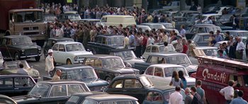 Movie still from “The Italian Job” (1969), directed by Peter Collinson – A large group of cars parked on the side of the street; Extreme Wide shot, High angle