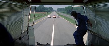 Movie still from “The Italian Job” (1969), directed by Peter Collinson – A group of cars driving down a road; Extreme Wide shot, High angle