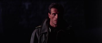 Movie still from “The Keep” (1983), directed by Michael Mann – A person wearing a jacket; Close Up shot, Low angle