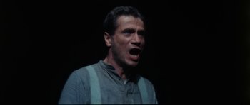 Movie still from “The Keep” (1983), directed by Michael Mann – A person with his mouth wide open; Close Up shot, Low angle