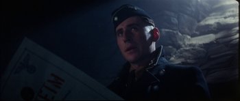 Movie still from “The Keep” (1983), directed by Michael Mann – A man in a military uniform is looking up; Close Up shot, Low angle