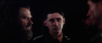 Movie still from “The Keep” (1983), directed by Michael Mann – A man with a beard is looking into the mirror; Close Up shot, Over the shoulder angle