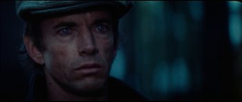 Movie still from “The Keep” (1983), directed by Michael Mann – A person wearing a hat and looking into the distance; Close Up shot, High angle