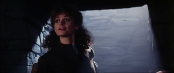 Movie still from “The Keep” (1983), directed by Michael Mann – A person with long curly hair; Close Up shot, Low angle