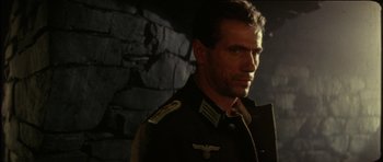 Movie still from “The Keep” (1983), directed by Michael Mann – A person wearing a military uniform; Close Up shot, Low angle