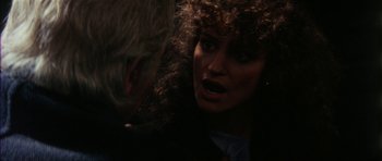 Movie still from “The Keep” (1983), directed by Michael Mann – A man and a woman talking to each other; Close Up shot, Over the shoulder angle