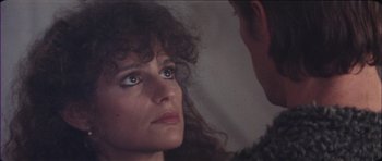 Movie still from “The Keep” (1983), directed by Michael Mann – A person looking at the camera; Close Up shot, Over the shoulder angle