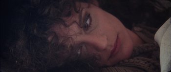 Movie still from “The Keep” (1983), directed by Michael Mann – A woman's face as she lays down; Close Up shot, High angle