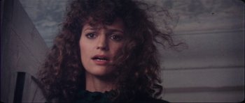 Movie still from “The Keep” (1983), directed by Michael Mann – A person with curly brown hair; Close Up shot, Low angle
