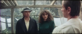 Movie still from “The Keep” (1983), directed by Michael Mann – A man and a woman standing next to each other; Close Up shot, Over the shoulder angle