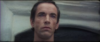 Movie still from “The Keep” (1983), directed by Michael Mann – A person with blue eyes; Close Up shot, Low angle