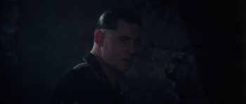 Movie still from “The Keep” (1983), directed by Michael Mann – A person wearing a military uniform; Close Up shot, Over the shoulder angle