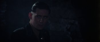 Movie still from “The Keep” (1983), directed by Michael Mann – A person wearing a military uniform; Close Up shot, Over the shoulder angle