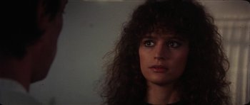 Movie still from “The Keep” (1983), directed by Michael Mann – A person with long curly hair; Close Up shot, Low angle