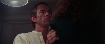 Movie still from “The Keep” (1983), directed by Michael Mann – A person holding a person's arm; Close Up shot, Over the shoulder angle