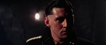 Movie still from “The Keep” (1983), directed by Michael Mann – A person wearing a leather jacket; Close Up shot, Low angle