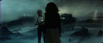 Movie still from “The Keep” (1983), directed by Michael Mann – Two people are standing in the middle of the night; Medium shot, High angle