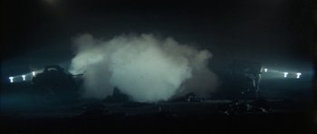 Movie still from “The Keep” (1983), directed by Michael Mann – A cloud of smoke is coming out of the ground; Extreme Wide shot, Low angle