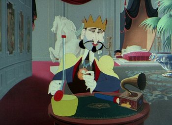 Movie still from “The King and the Mockingbird” (1980), directed by Paul Grimault – A cartoon king sitting at a table in a room; Medium shot, Overhead angle