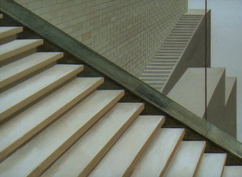 Movie still from “The King and the Mockingbird” (1980), directed by Paul Grimault – A view of some steps in a building with a railing on one side; Extreme Wide shot, Overhead angle