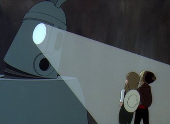 Movie still from “The King and the Mockingbird” (1980), directed by Paul Grimault – A robot with a woman looking at it through a lens; Medium shot, Over the shoulder angle