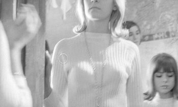 Movie still from “The Knack... and How to Get It” (1965), directed by Richard Lester – A black and white photo of a woman in a white sweater; Close Up shot, High angle