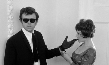 Movie still from “The Knack... and How to Get It” (1965), directed by Richard Lester – A man and a woman are holding a shoe; Medium shot, Over the shoulder angle