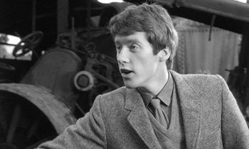 Movie still from “The Knack... and How to Get It” (1965), directed by Richard Lester – A man in a suit and tie looking at the camera; Close Up shot, Over the shoulder angle